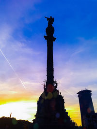 Low angle view of silhouette statue against sky during sunset