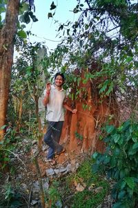 Portrait of man standing against plants