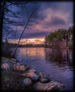 Scenic view of lake against sky at sunset