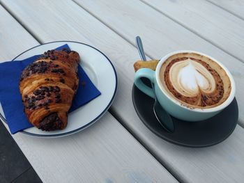 High angle view of cappuccino and coffee on table