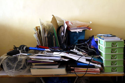 Stack of arranged on table against wall