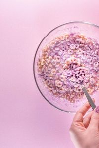 Close-up of hand holding ice cream in glass