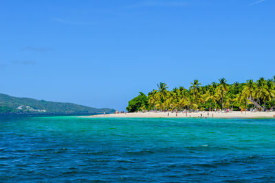 Scenic view of sea against blue sky