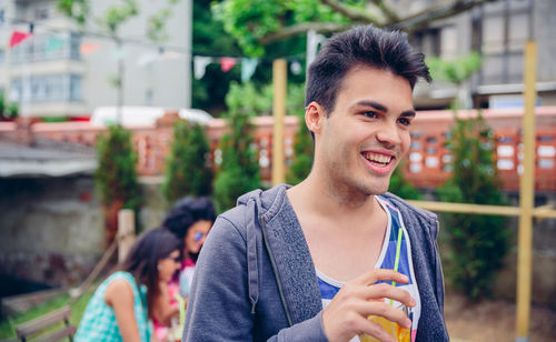 Smiling man having juice at restaurant