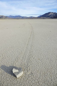 Surface level of barren land against sky