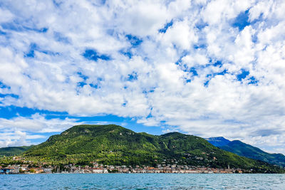 Scenic view of sea and mountains against sky