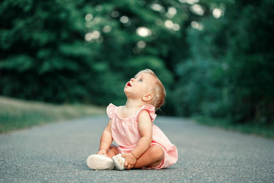 Cute girl sitting on road