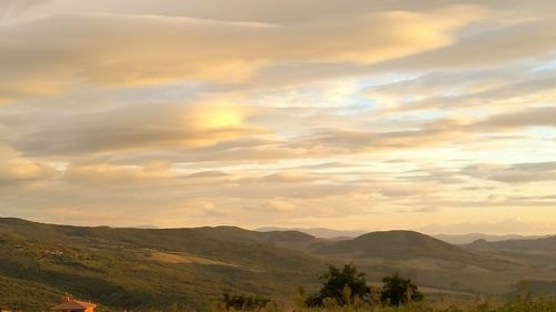 Scenic view of mountains against cloudy sky