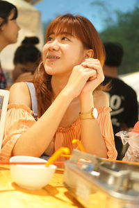 Portrait of a smiling girl sitting on table