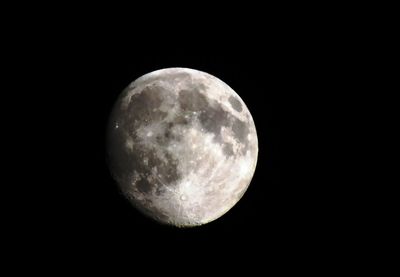 Low angle view of moon against clear sky at night