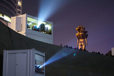 Low angle view of illuminated building against sky at night