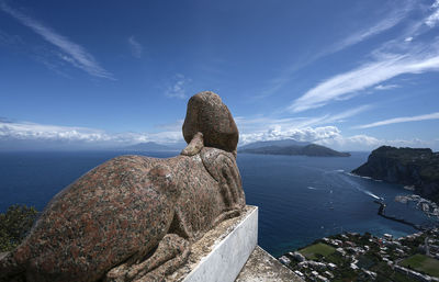 Statue against sea during sunny day