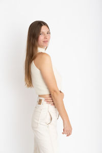 Young woman standing against white background