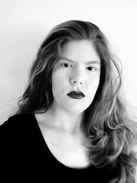 Close-up portrait of beautiful young woman over white background