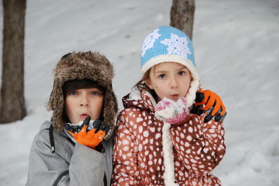 Siblings playing with snow