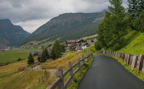 Panoramic shot of road amidst buildings against sky