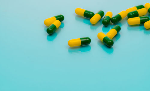 Tramadol pills. green-yellow capsule pills on blue background. tramadol is a strong painkiller.