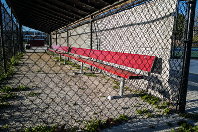 Empty red baseball dugout bench