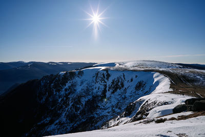 Scenic view of snowcapped mountains against sky