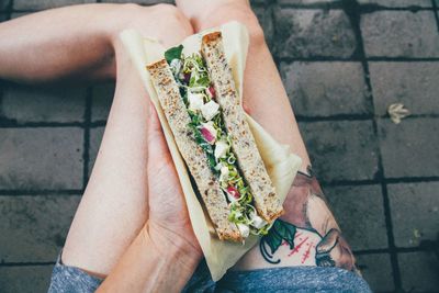 Close-up of woman holding sandwich