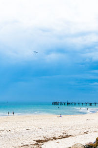 Scenic view of beach against blue sky