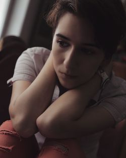 Close-up portrait of beautiful woman sitting at home