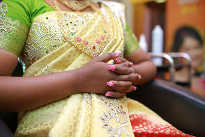 Midsection of woman wearing traditional clothing