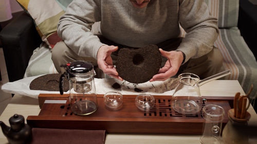 Midsection of man holding food at home