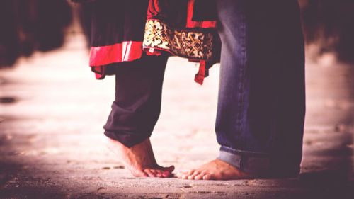 Low section of friends standing on street