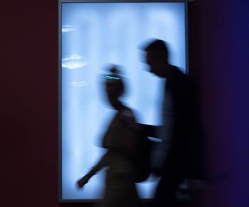 Blurred motion of people walking in corridor