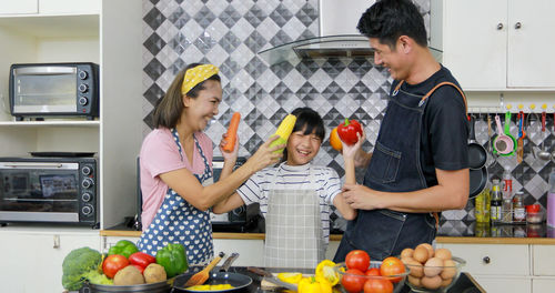 People standing by fruits at home