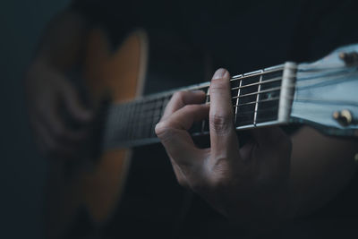 Cropped hand playing guitar