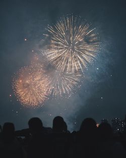 Low angle view of firework display at night