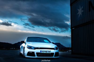 View of car on road against cloudy sky