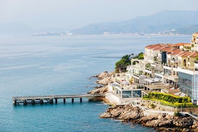 High angle view of sea and buildings against sky