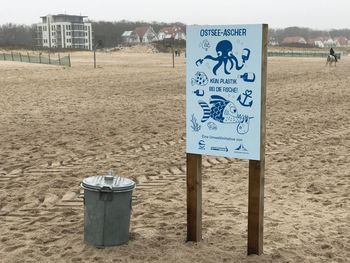 Information sign on sand at beach