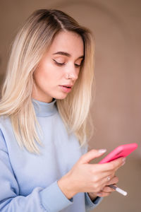 Beautiful young woman using mobile phone