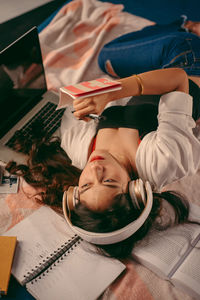 High angle view of girl sitting on table