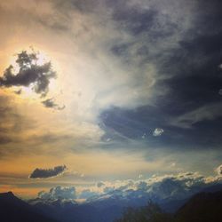 Scenic view of mountains against cloudy sky