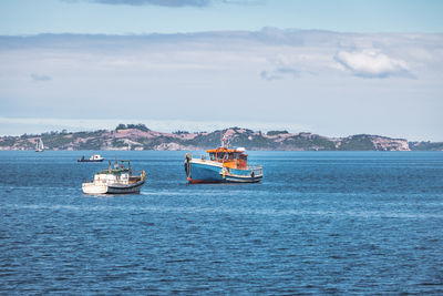 Boat sailing on sea against sky