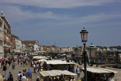 People on street against buildings in city