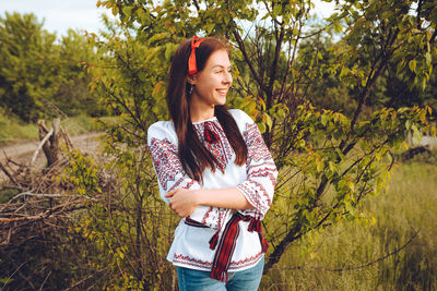 Photo of a smiling young woman in ethnic ukrainian shirt