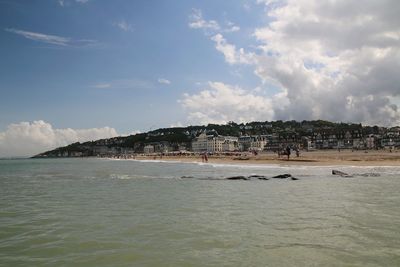 View of beach against cloudy sky