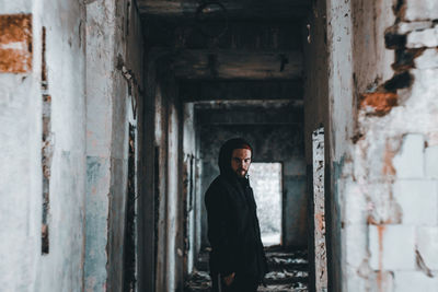 Man standing in abandoned building