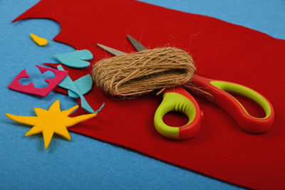 Scissors with craft materials on table