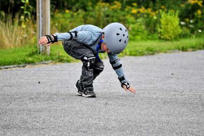 Low section of boy standing on road