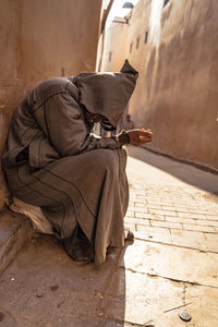 Man sleeping on footpath