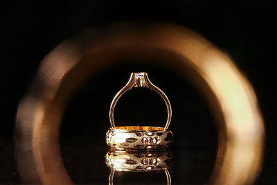 Close-up of wedding rings on table in darkroom