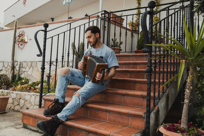 Portrait of young man using mobile phone