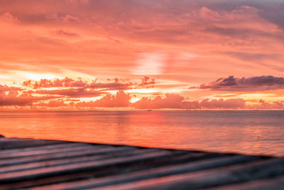 Scenic view of sea against romantic sky at sunset